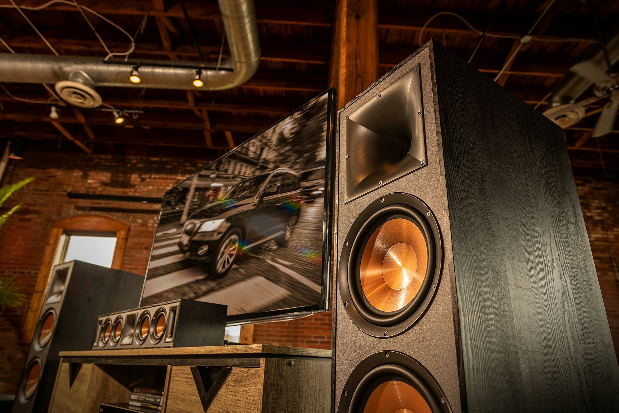 Close up of a Klipsch speaker system surrounding a tv
